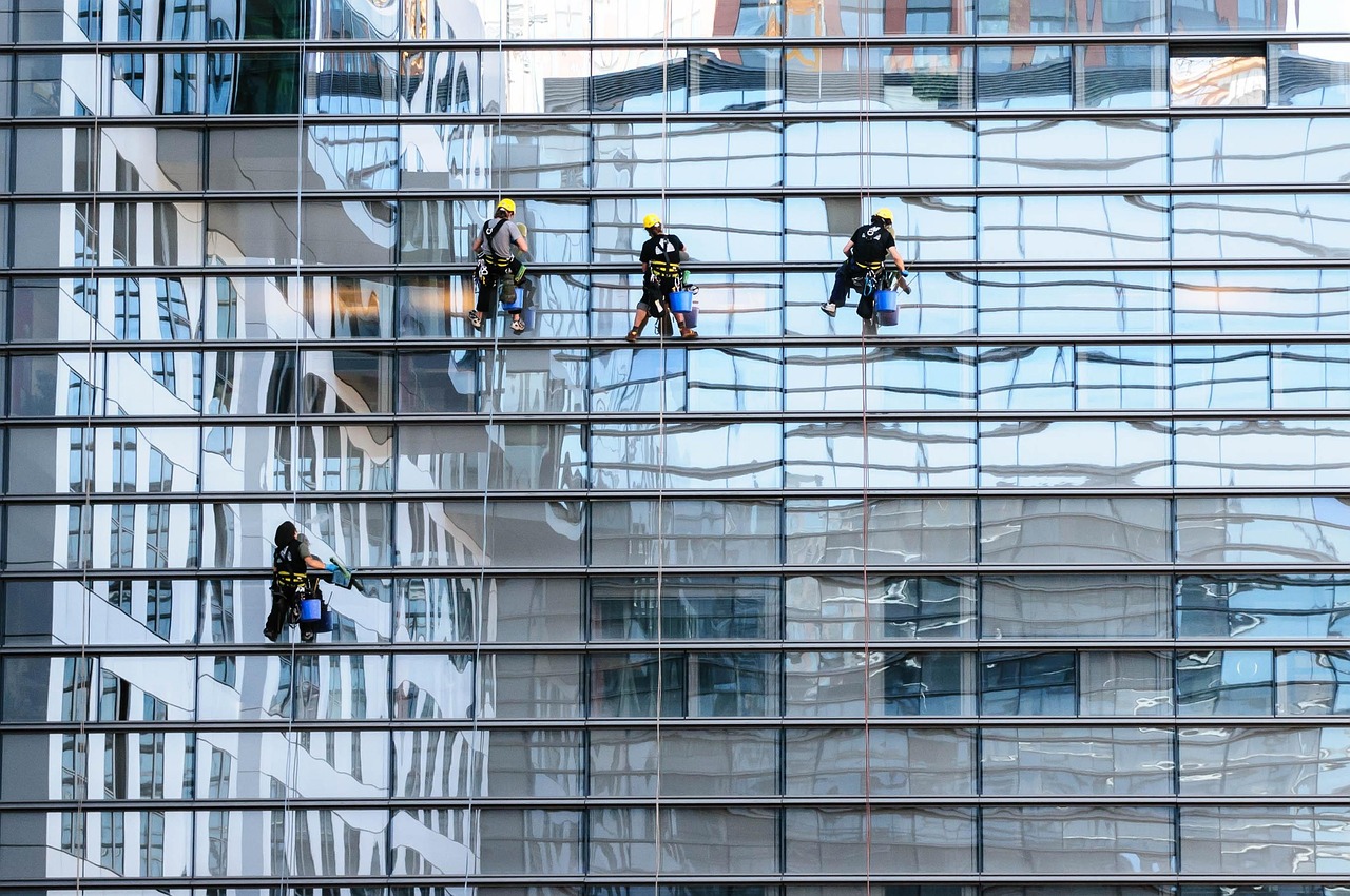A squeegee drawing a clean line down a wet window